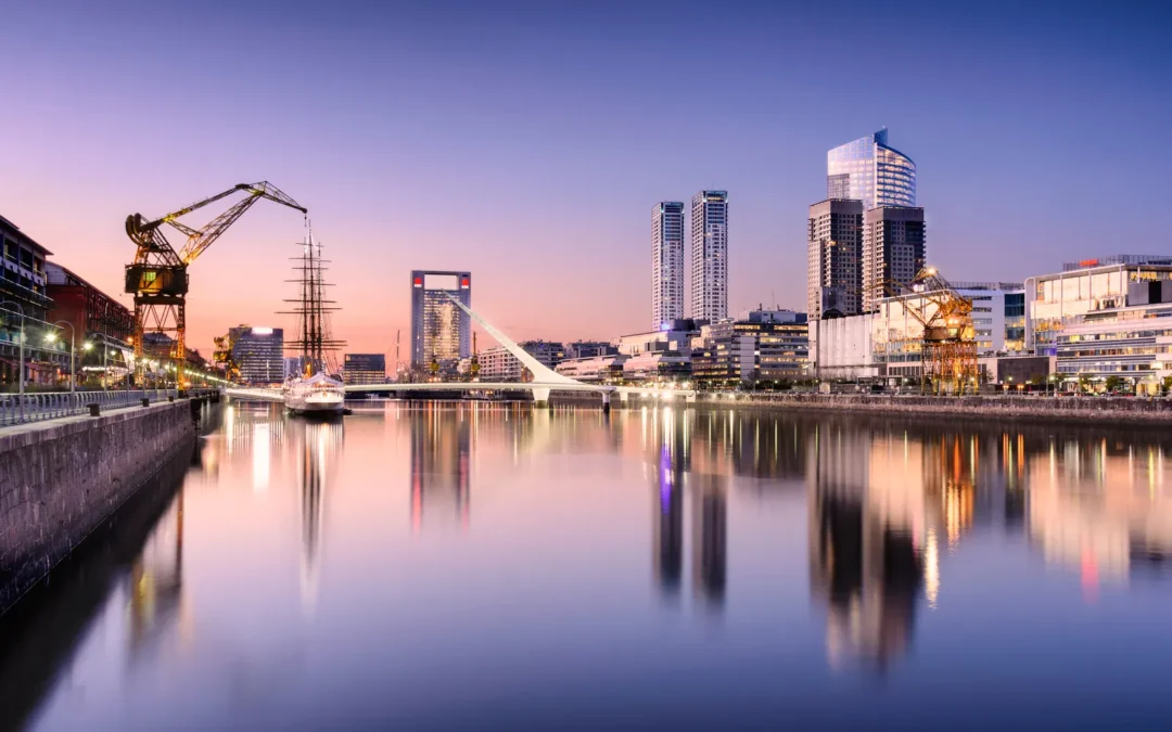 Skyline de Puerto Madero al atardecer con complejo de torres corporativas reflejado en el agua, distrito empresarial premium de Buenos Aires