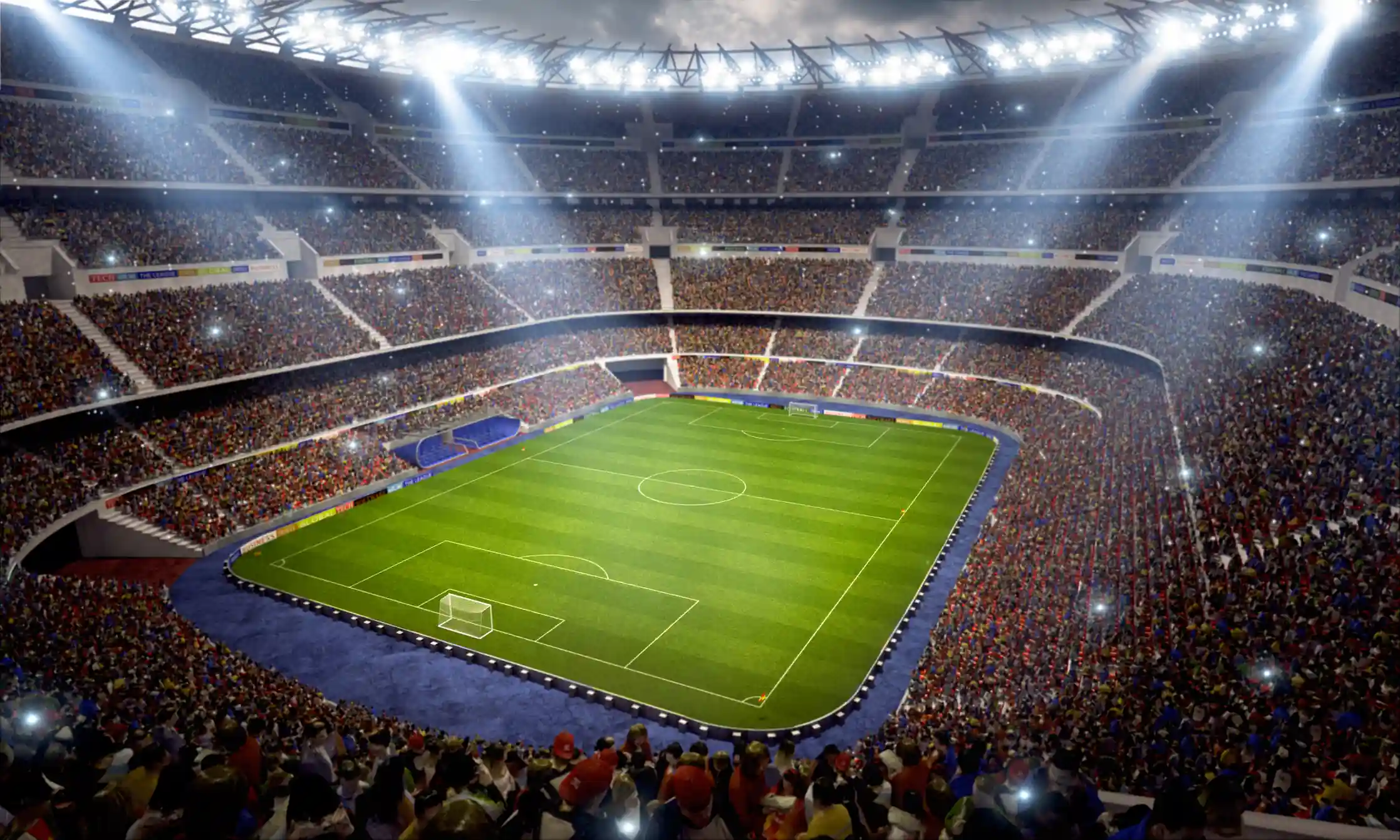 Vista panorámica de un estadio deportivo nocturno iluminado con la cancha verde y la hinchada completa